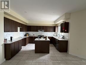 Southgate apartment for rent - A large kitchen with brown cabinets and a marble counter top.