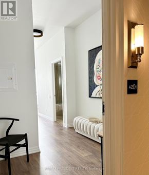 Toronto (Waterfront Communities) condo for rent - A hallway with a chair and a painting on the wall.