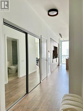 Toronto (Waterfront Communities) condo for rent - A hallway with a person standing in the distance.