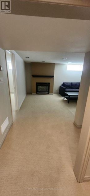 Oshawa (Centennial) apartment for rent - A living room with a fireplace and a couch.