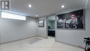 Oshawa (Centennial) apartment for rent - A room with a bed and a picture of a train station on the wall.