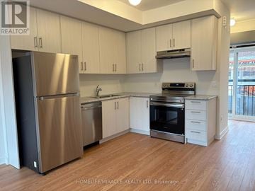 Aurora (Aurora Village) townhouse for rent - A kitchen with white cabinets and stainless steel appliances.