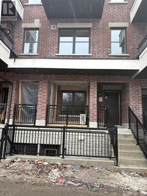 Aurora (Aurora Village) townhouse for rent - A red brick house with a black iron fence.