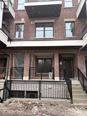 Aurora (Aurora Village) townhouse for rent - A red brick building with a black iron fence in front.