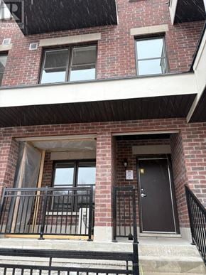 Aurora (Aurora Village) townhouse for rent - A brick building with a black door and windows.