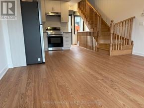 Aurora (Aurora Village) townhouse for rent - A wooden floor leads to a staircase in a home.