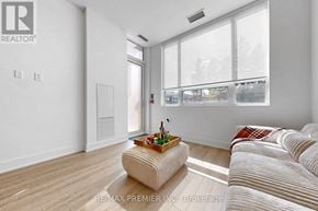 King (King City) condo for rent - A living room with a couch, a coffee table, and a window.