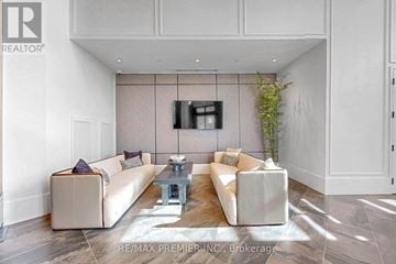 King (King City) condo for rent - A living room with a white couch and a coffee table.