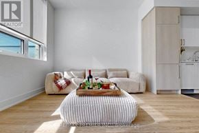 King (King City) condo for rent - A living room with a couch, a coffee table, and a cabinet.