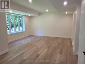 Wasaga Beach apartment for rent - A room with wooden flooring and a window letting in natural light.