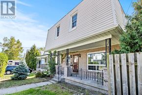 Welland (Prince Charles) multi-family for rent - A house with a white siding and a brown door is shown.