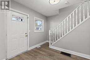 Welland (Prince Charles) multi-family for rent - A white door with a window in the middle of a room.