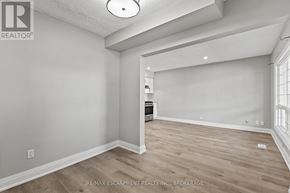Welland (Prince Charles) multi-family for rent - A room with a wooden floor and white walls.