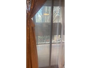 Richmond apartment for rent - A window with a curtain and a glass door.