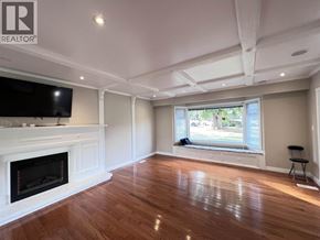 Coquitlam apartment for rent - A living room with a fireplace and a television.