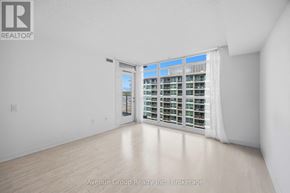 Toronto (Bayview Village) condo for rent - A white room with a sliding door leading to a balcony.