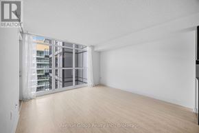 Toronto (Bayview Village) condo for rent - A large, empty room with a sliding glass door leading to a balcony.