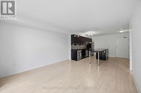 Toronto (Bayview Village) condo for rent - A spacious room with wooden flooring and a kitchenette in the corner.