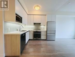 Markham (Unionville) condo for rent - A kitchen with wooden cabinets and a refrigerator.