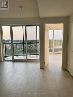 Toronto (Humber Heights) condo for rent - A spacious room with a view of the city through large windows.