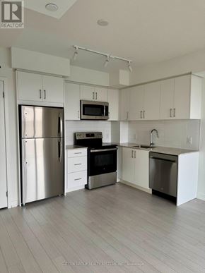 Toronto (Humber Heights) condo for rent - A modern kitchen with white cabinets and stainless steel appliances.