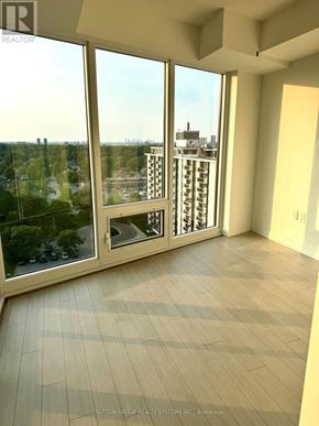 Toronto (Humber Heights) condo for rent - A room with a view of a cityscape through large windows.