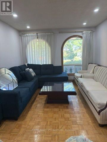 Brampton (Northgate) apartment for rent - A living room with a dark blue couch and a white couch.