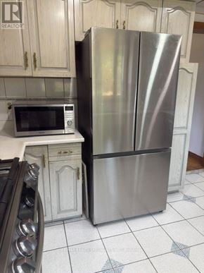 Brampton (Northgate) apartment for rent - A silver refrigerator stands in a kitchen next to a microwave.