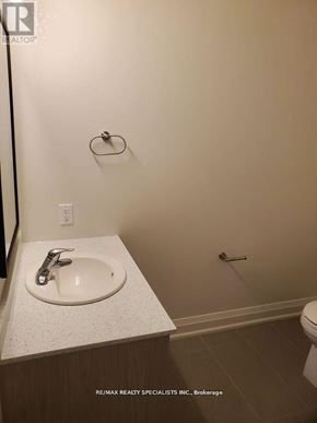 Hamilton (Beasley) condo for rent - A bathroom with a sink, toilet, and a towel rack.