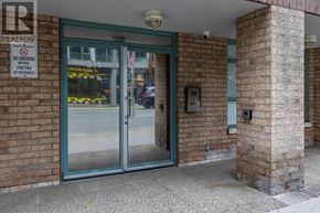 Toronto (Moss Park) condo for rent - A glass door with a sign that says no smoking within 30 feet of entrance.