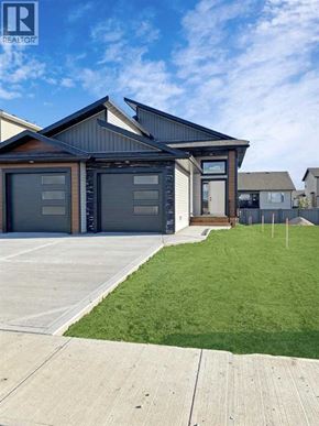 Grande Prairie apartment for rent - A modern house with a large garage is for sale.