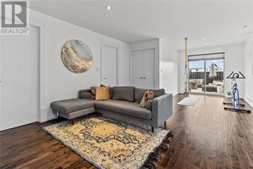St. John's apartment for rent - A living room with a grey sofa and a rug.