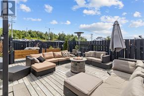St. John's apartment for rent - A patio with a fire pit and seating area.