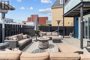 St. John's apartment for rent - A patio with a fire pit and seating area.