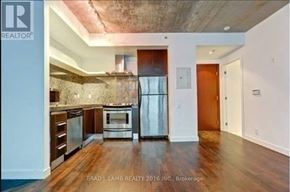 Toronto (Waterfront Communities) condo for rent - A kitchen with a refrigerator, oven, and cabinets.