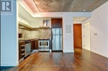 Toronto (Waterfront Communities) condo for rent - A kitchen with a refrigerator, oven, and cabinets.