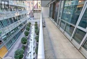 Toronto (Waterfront Communities) condo for rent - A long, narrow corridor with trees on the sides.