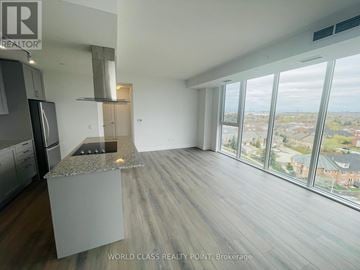 Vaughan (Beverley Glen) condo for rent - A modern kitchen with a granite countertop and a view of the city.