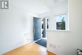 Caledon townhouse for rent - A room with a door and a chair in it.