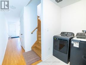 Caledon townhouse for rent - A hallway with a staircase and two ovens.