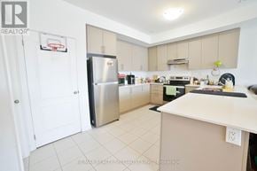 Caledon townhouse for rent - A kitchen with a refrigerator, stove, and oven.