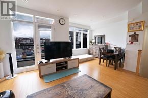 Caledon townhouse for rent - A living room with a television and a dining table.