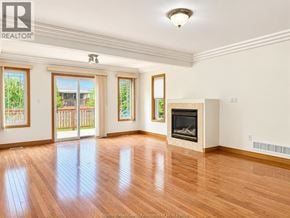 Windsor apartment for rent - A large empty room with a fireplace and wooden floors.
