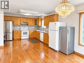 Windsor apartment for rent - A kitchen with wooden cabinets and a white refrigerator.