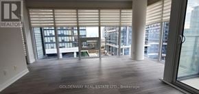 Toronto (Niagara) condo for rent - A room with a view of the city through large windows.