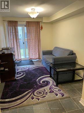 Newmarket (Woodland Hill) apartment for rent - A living room with a grey couch and a purple rug.