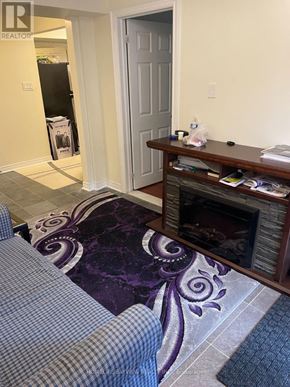 Newmarket (Woodland Hill) apartment for rent - A living room with a purple rug and a fireplace.