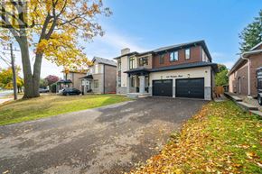Burlington (Roseland) apartment for rent - A house with a driveway and a tree with yellow leaves.