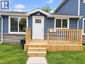 Amherstburg apartment for rent - A blue house with a white door and a wooden deck.