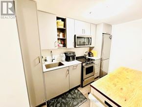 Toronto (Mimico) condo for rent - A small kitchen with a wooden counter top.